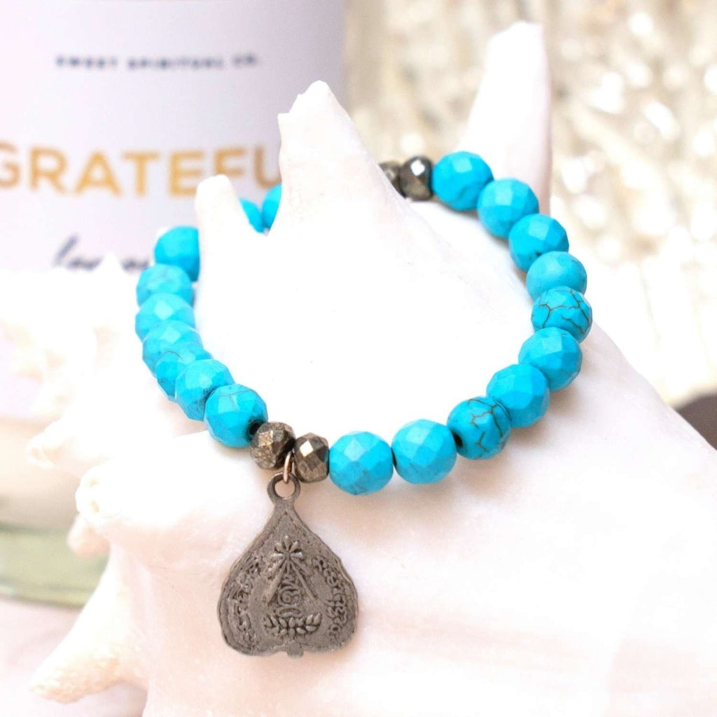 You are viewing a natural Turquoise gemstone Bracelet - This unique gemstone bracelet is adorned with a buddha charm and has pyrite spacers!