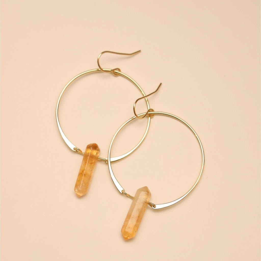 Raw Citrine Thin and large Hoop earrings Hoop measures 1.5&quot; in diameter. Citrine Dimensions: 2.3&quot; l x 0.3&quot; w x 1.5&quot; -- These double pointed crystal earrings are handcrafted out of 18kt gold over sterling silver