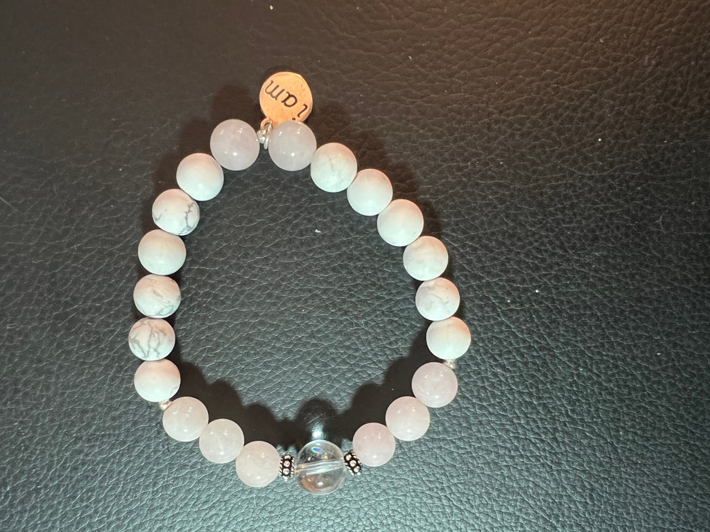 Rose Quartz and Howlite Bracelet - Stretch. Made with gemstones in Rose Quartz which have a very slight blush pink and white and one center crystal ball. There is a .925 sterling silver I am charm and silver spacers.