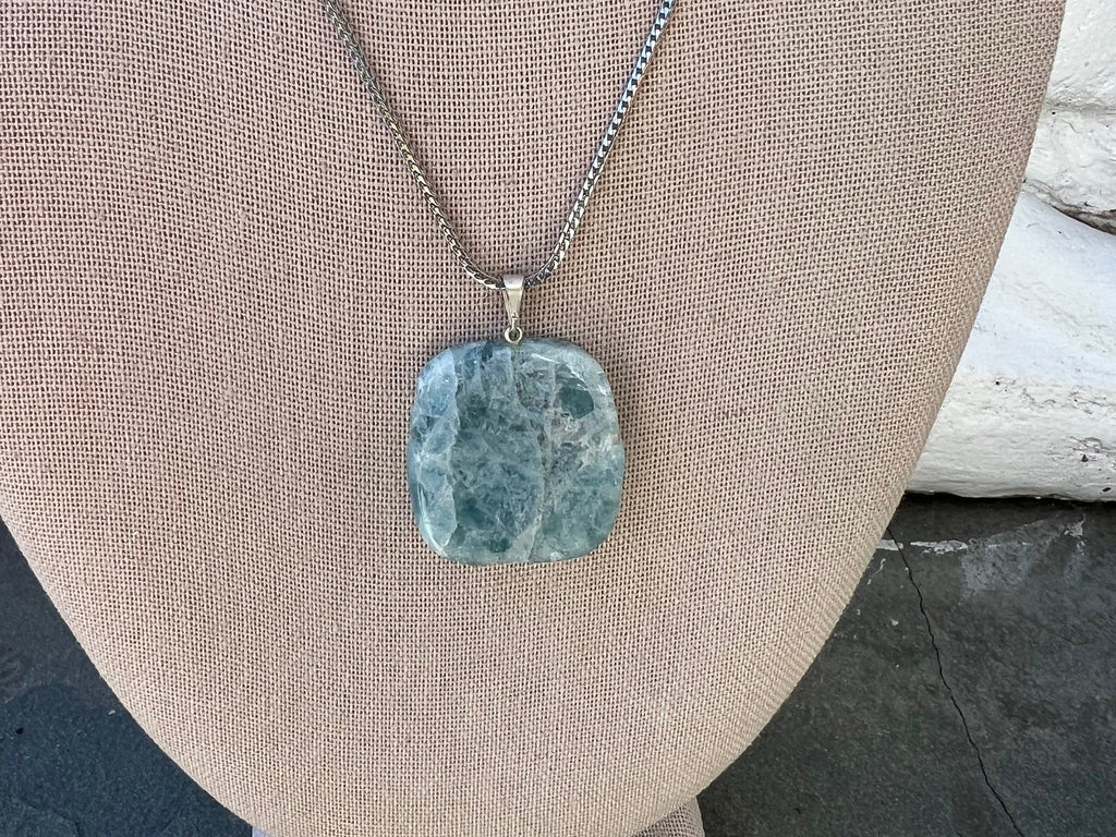 Your polished aquamarine slab pendant is on an 18&quot; sterling silver .925 rhodium plated chain so it will not tarnish. Each stone is unique and measures approximately 1 1/4. You may choose your special aquamarine crystal or let it choose you!