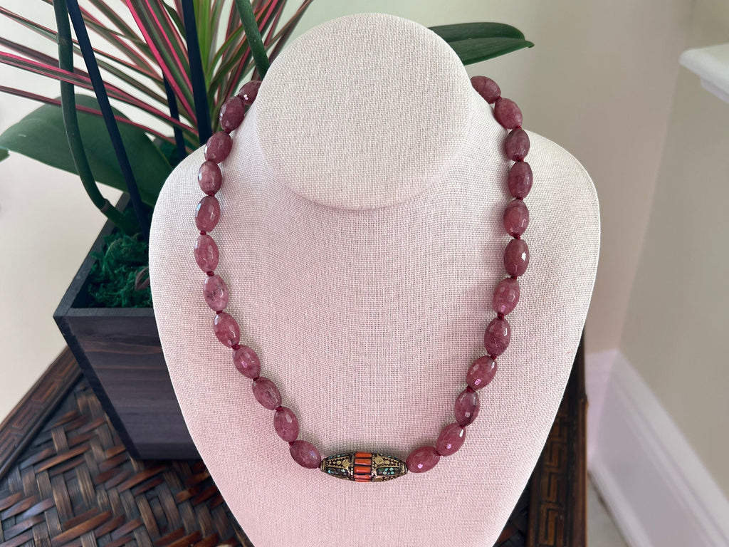 This beautiful Mookaite necklace is hand-knotted and gold vermeil is over sterling silver. The beads are 10mm Faceted Barrel cut Mookaite with 1 1/2&quot; center focal bead: Turquoise, Carnelian Brass, Gold Vermeil clasp. The necklace is 20 inches.