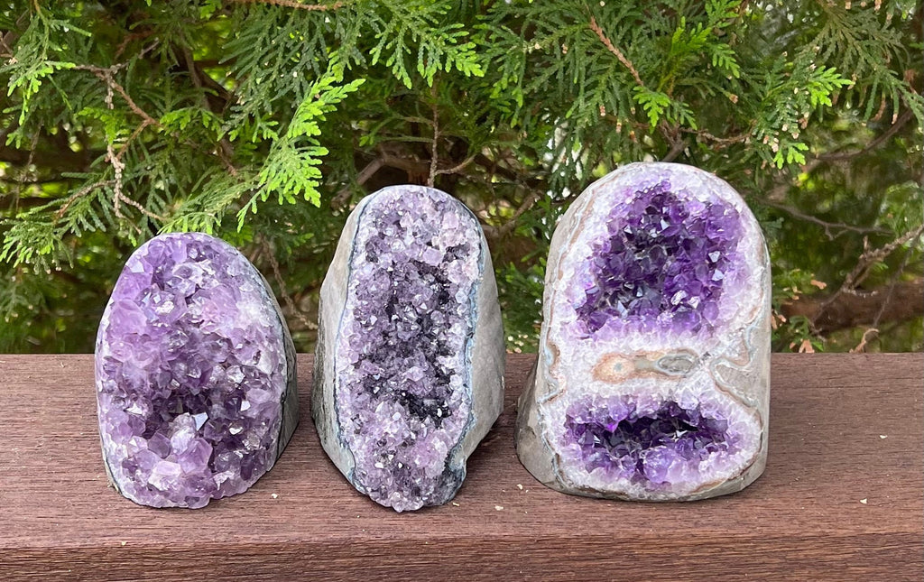 These 3 beautiful Amethyst Geode Crystal Eggs are formed out of Natural AAA quality Amethyst crystal. The front side of each geode has raw purple druzy crystals and the back of the geodes are a natural slate color and lightly poished.